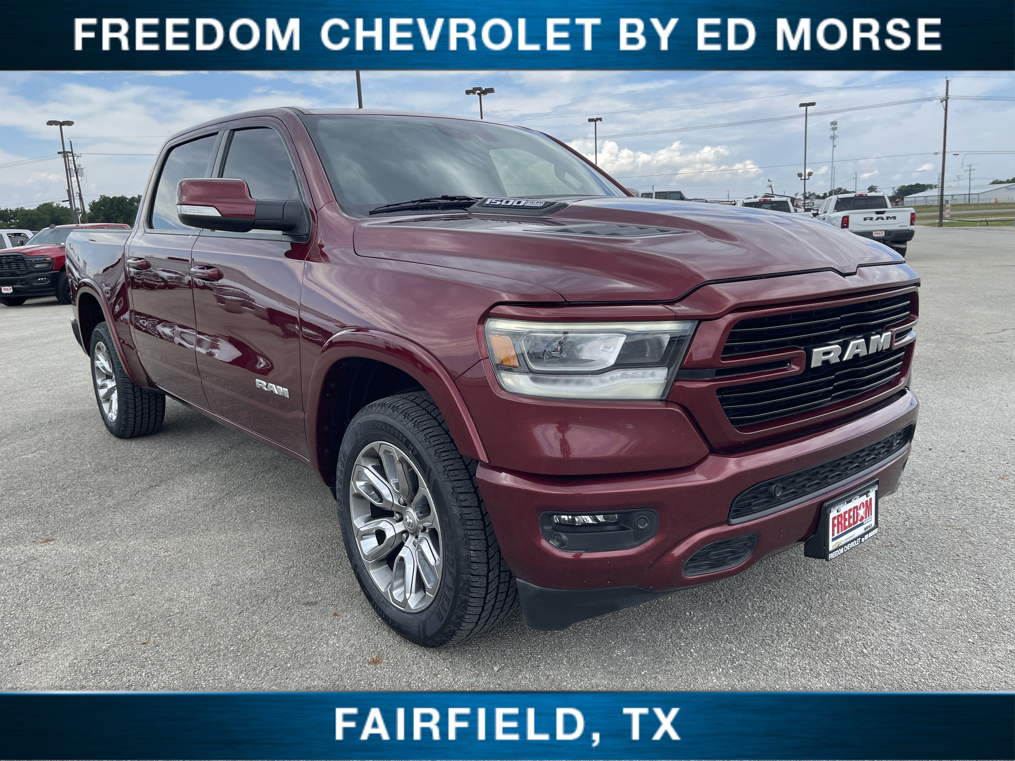 2021 RAM 1500 Laramie in Delmonico Red Pearlcoat — front three-quarter view