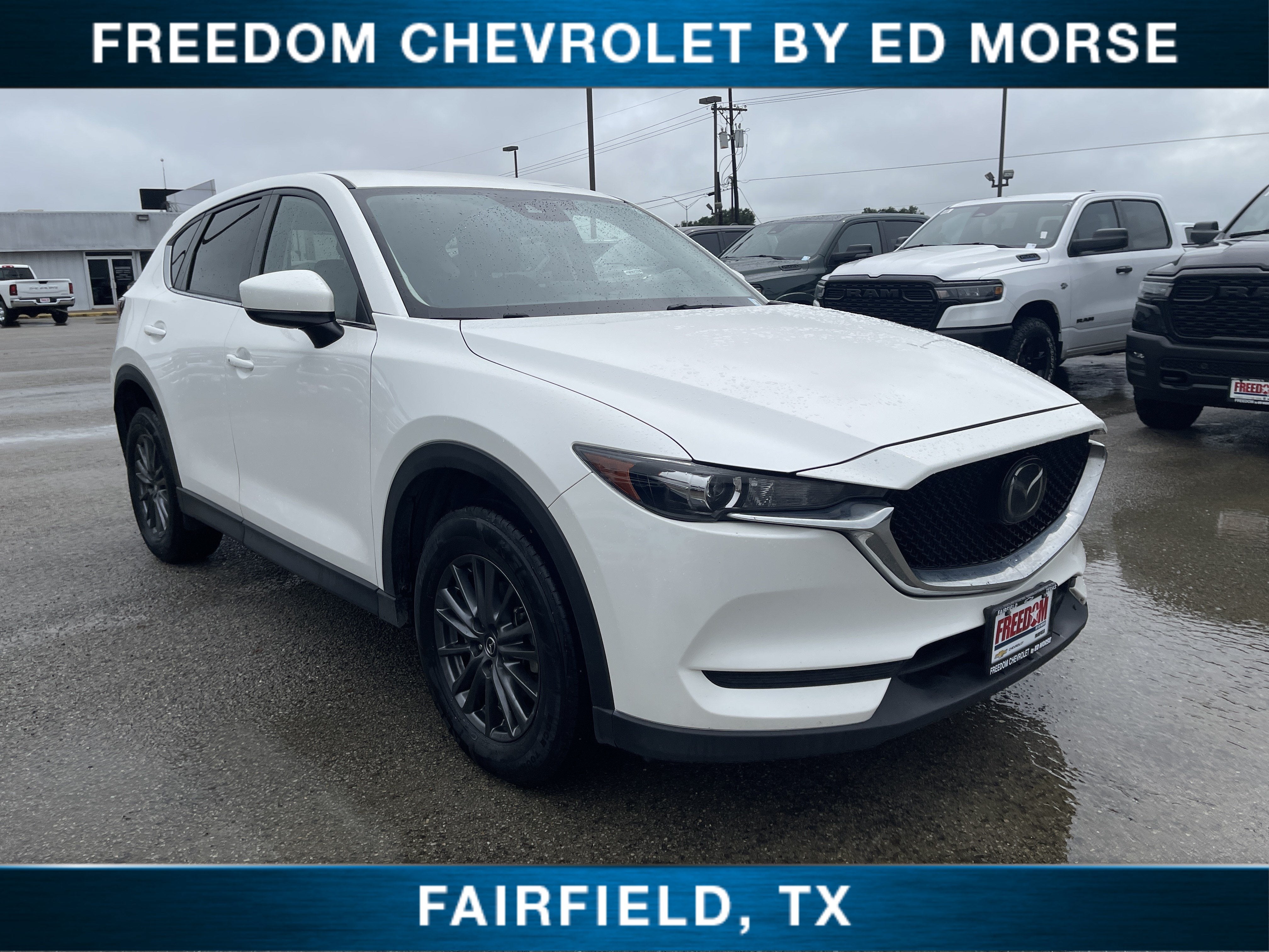 2021 Mazda Mazda CX-5 Touring in Snowflake White Pearl Mica — front three-quarter view